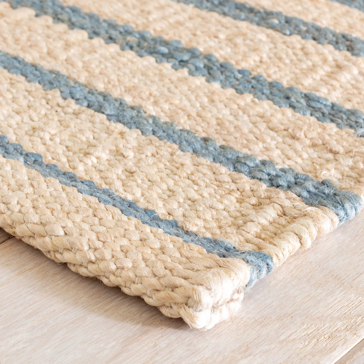 Dash & Albert Moana Stripe Handwoven Jute Rug in Blue, corner detail