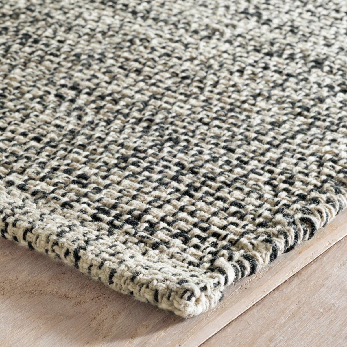 Dash & Albert Marled Handwoven Cotton Rug in Black, corner detail