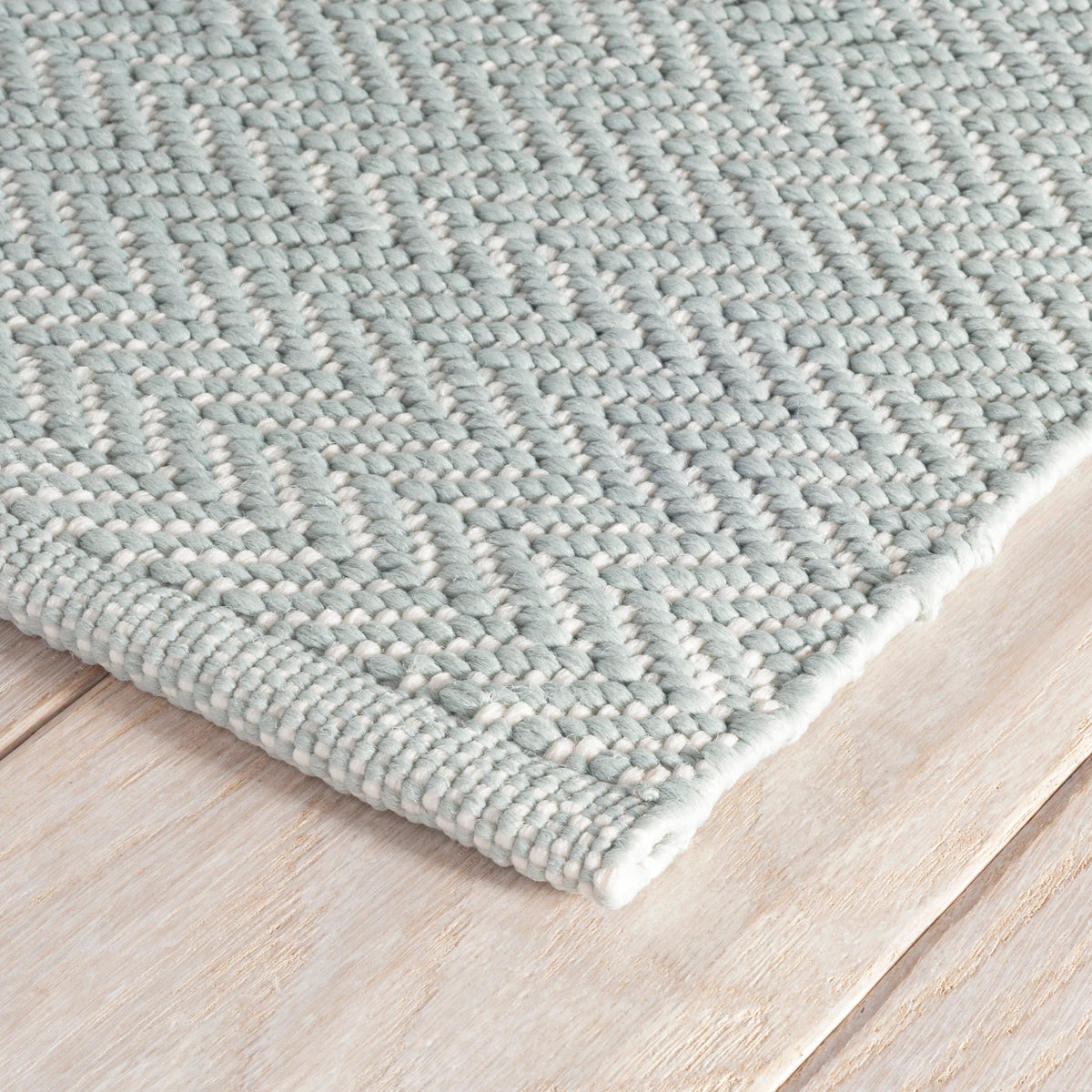 Dash & Albert Herringbone Handwoven Indoor/Outdoor Rug in Light Blue / Ivory, corner detail