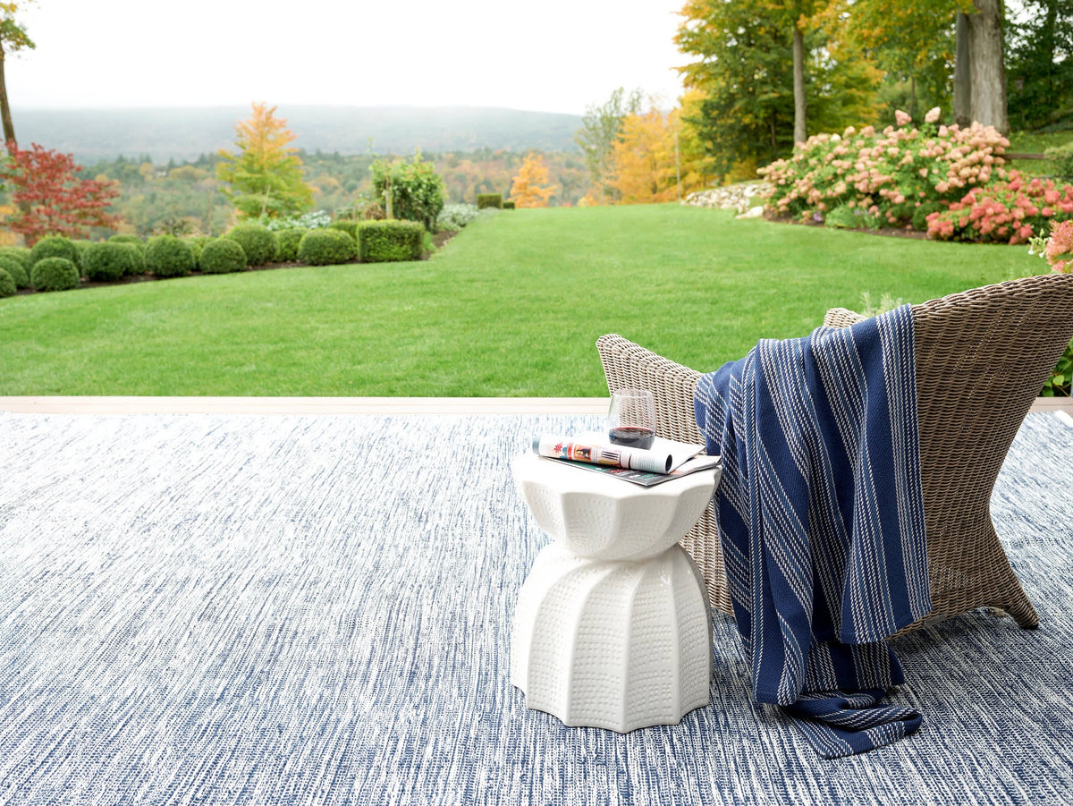 Dash & Albert Tideline Handwoven Indoor/Outdoor Rug in Navy, garden patio setting