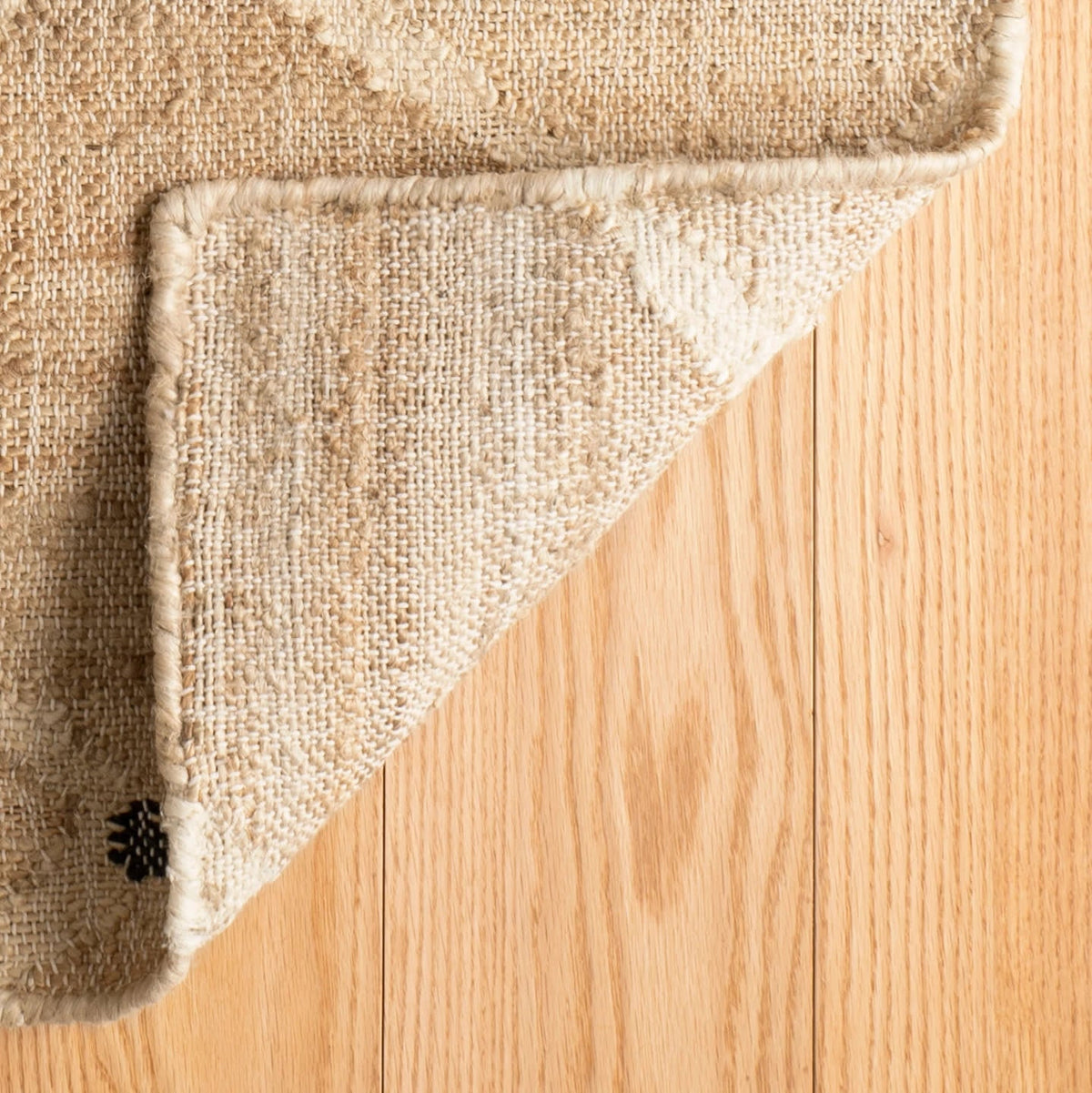 Dash & Albert Kali Handwoven Jute Rug in Natural, corner turned back