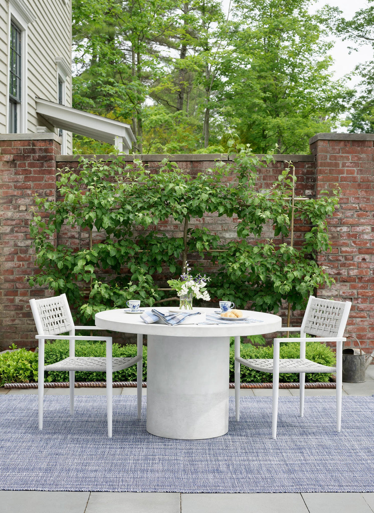 Dash & Albert Fusion Handwoven Indoor/Outdoor Rug in Blue, patio setting