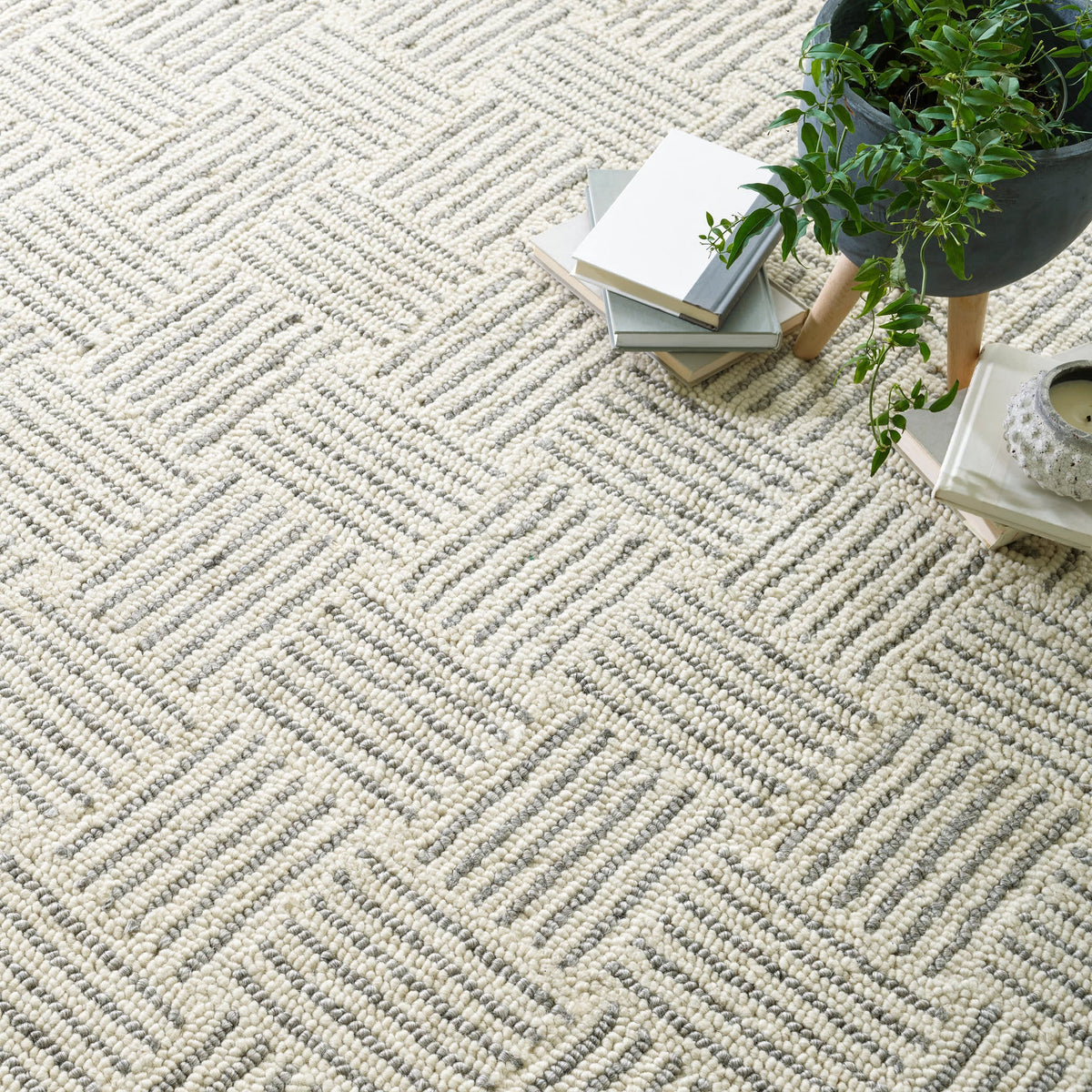 Dash & Albert Layers Hand Hooked Wool Rug in Grey, close-up with books