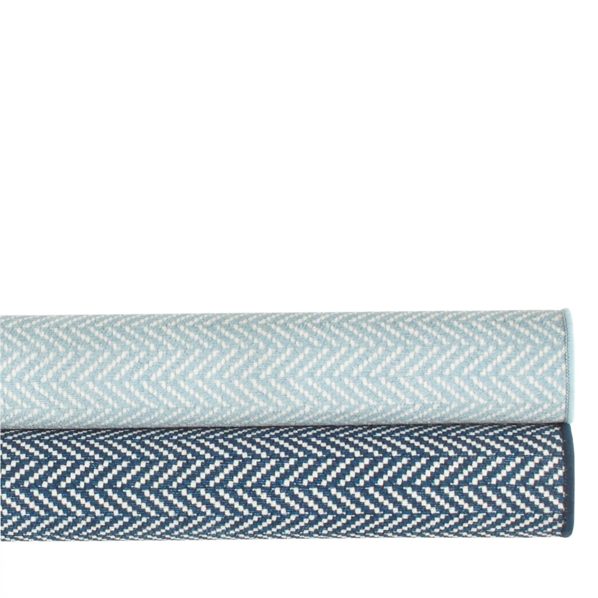 Dash & Albert Herringbone Machine Washable Rug in Navy and Swedish Blue, rolled stack