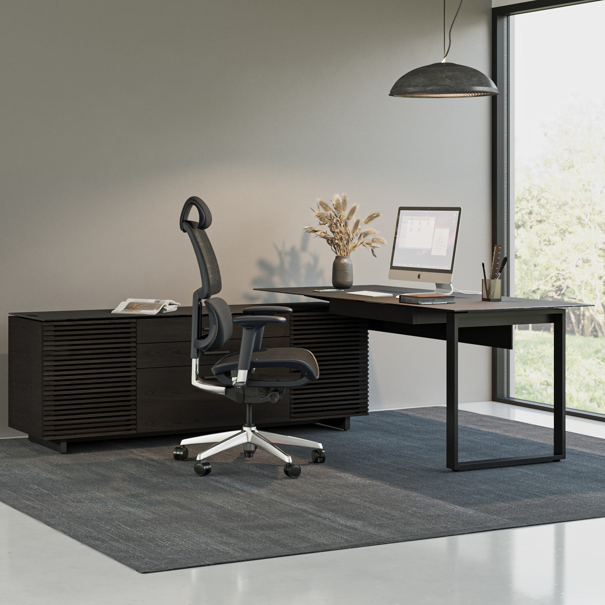 BDi Corridor 6531 L-Shaped Office Desk in Charcoal Stained Ash, in an office beside an open staircase