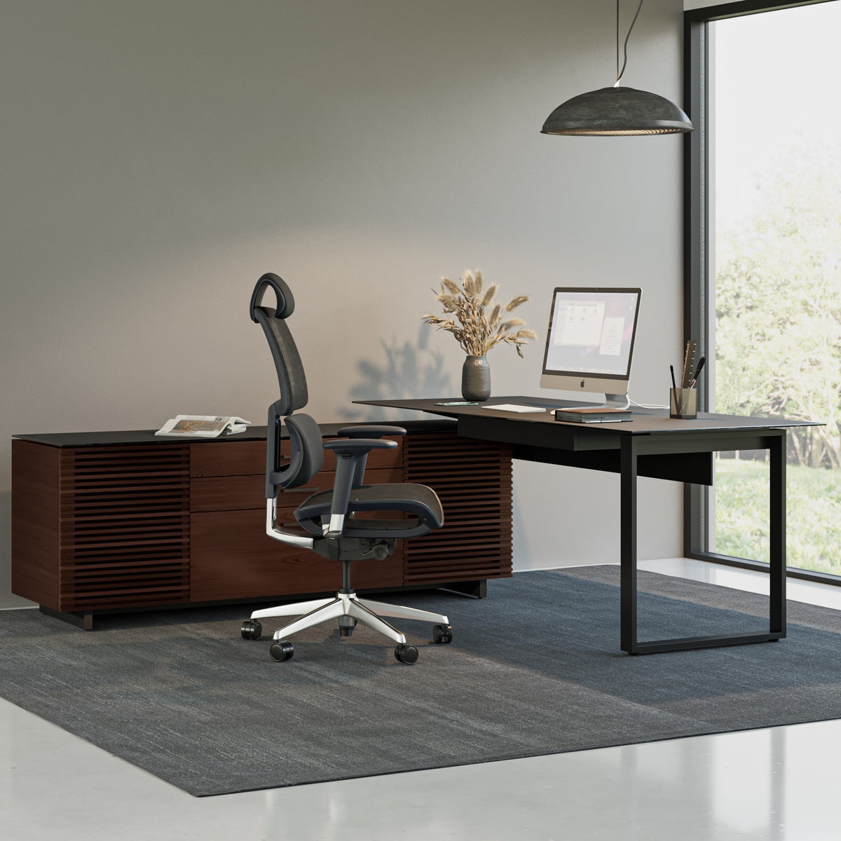 BDi Corridor 6531 L-Shaped Office Desk in Chocolate Stained Walnut, in an office beside an open staircase