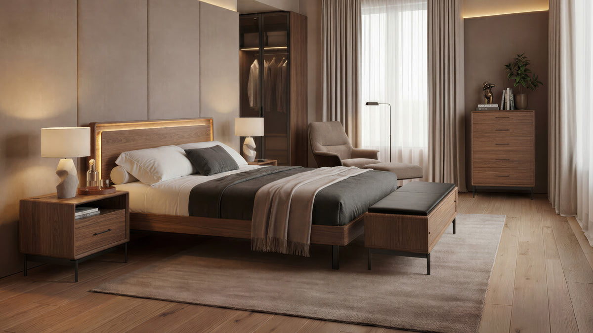 BDi Linq Bench in Pepper | Leather, with a Natural Walnut frame, at the foot of a bed in a bedroom with a chest
