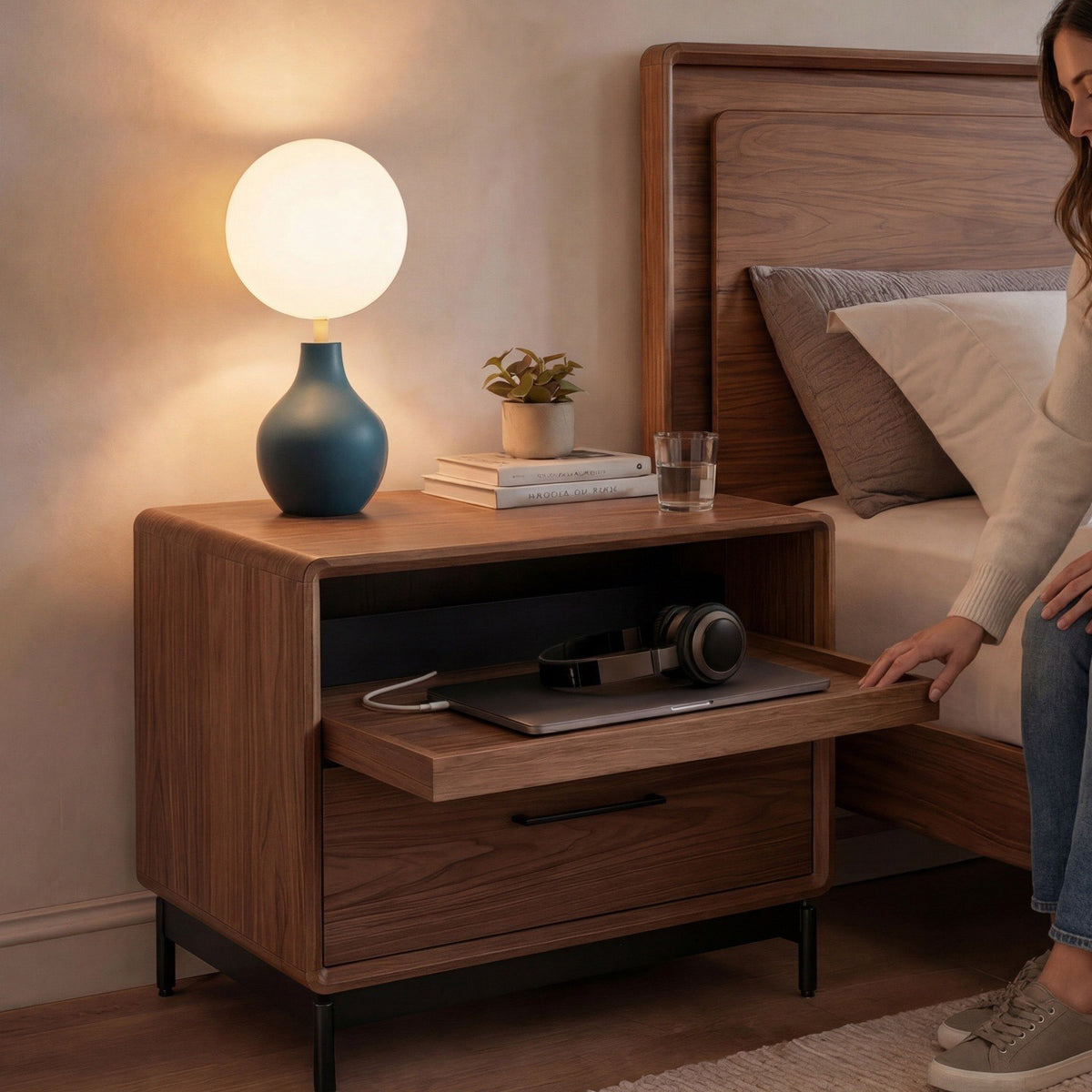 BDi Linq Nightstand in Natural Walnut, 28-inch, a woman pulling out the tray