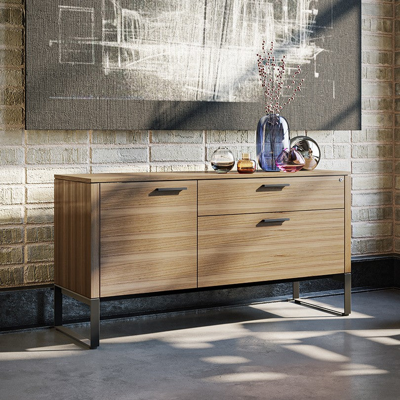 BDi Linea 6220 Multi Function Cabinet in Natural Walnut, against a brick wall, in a living area