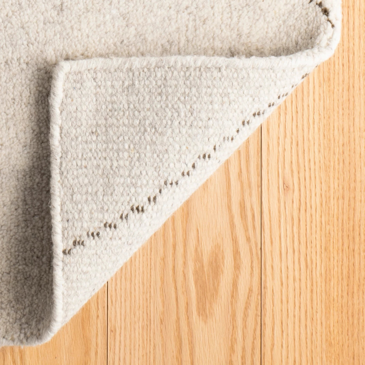 Dash & Albert Numa Hand Knotted Wool Rug in Charcoal, corner turned back