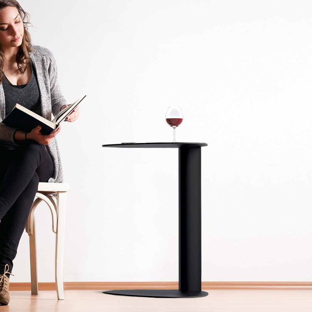 BDi Bink Laptop Stand / Side Table in Pepper, beside a chair, with a wine glass
