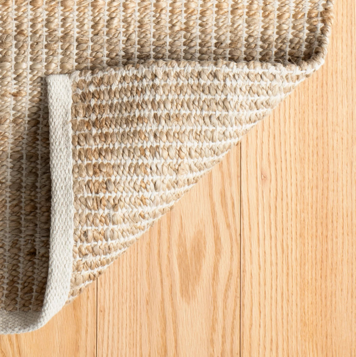 Dash & Albert Gridwork Handwoven Jute Rug in Ivory, corner turned back