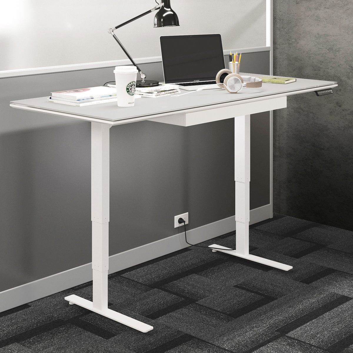 BDi Centro Sit+Stand Desk in Satin White on Oak with Grey Glass, 30 x 66 inch top, raised, beside a multi-function cabinet, in an office, 30" x 66" Top size