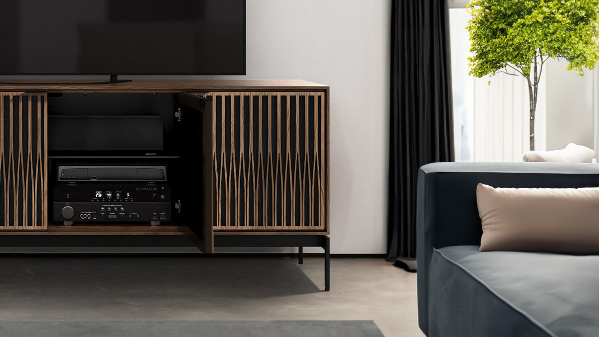 BDi Elements 8709 Media + Storage Console in Natural Walnut, door open with media equipment, close view beside a sofa, with Tune door fronts