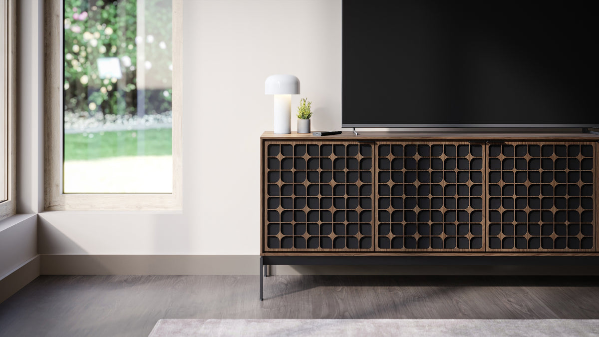 BDi Elements 8709 Media + Storage Console in Natural Walnut, under a TV by a garden window, with Constellation door fronts