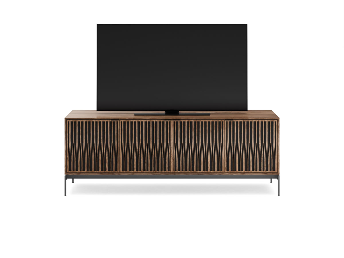 BDi Elements 8709 Media + Storage Console in Natural Walnut, front view with a TV, on white, with Tune door fronts