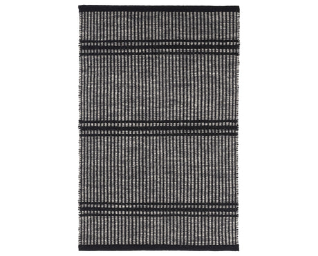 Rug with a Malta Handwoven pattern on a plain background