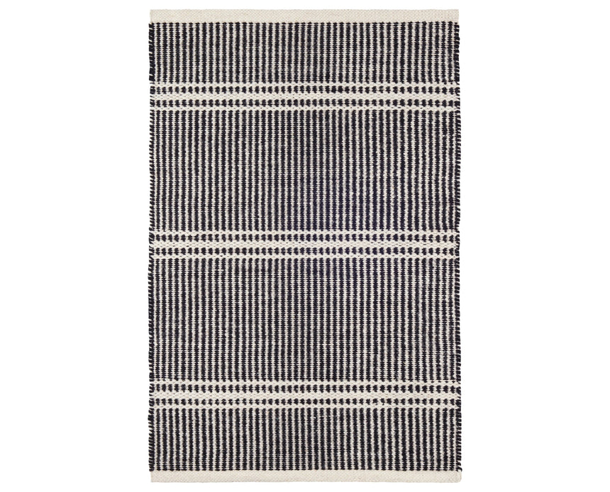 Rug with a Malta Handwoven pattern on a plain background