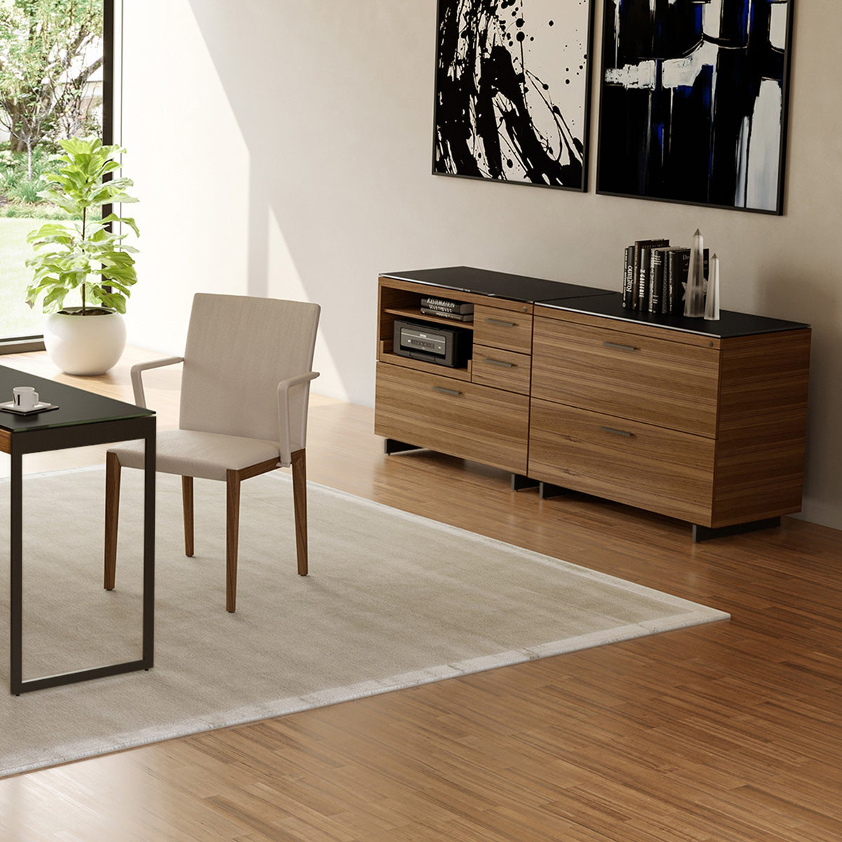 BDi Sequel 20 6116 Lateral File Cabinet in Natural Walnut, with a black base, beside a multi-function cabinet, in a home office
