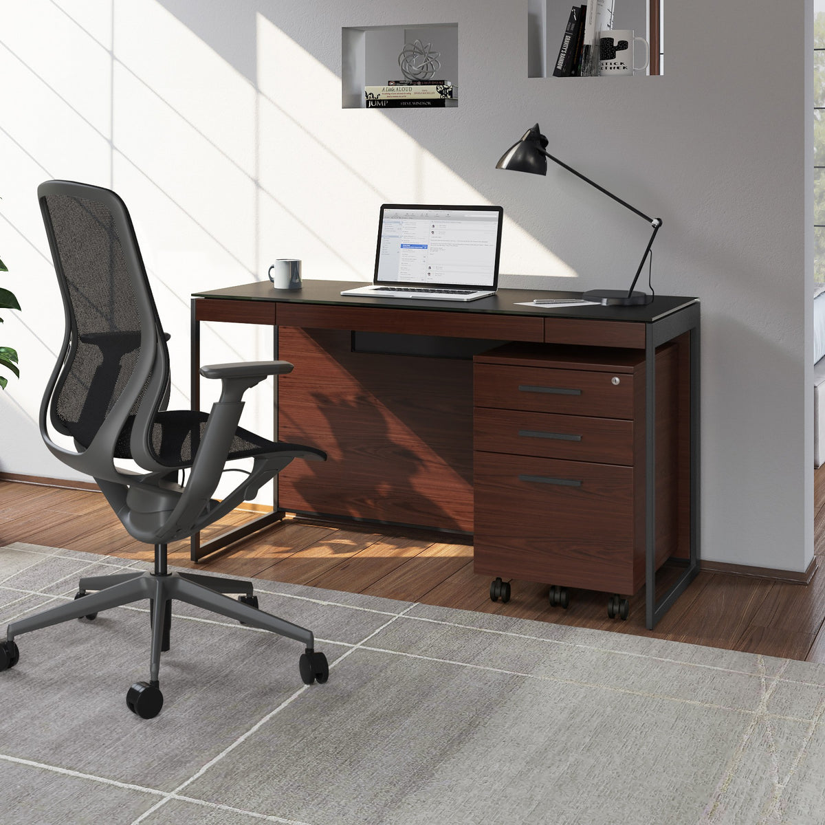 BDi Sequel 20 6103 Compact Laptop Desk in Chocolate Stained Walnut, with a black frame, mobile file and multi-function cabinet, in a home office