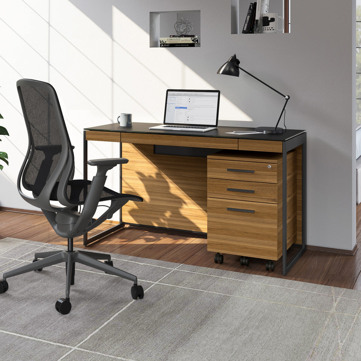 BDi Sequel 20 6103 Compact Laptop Desk in Natural Walnut, with a black frame, mobile file and multi-function cabinet, in a home office