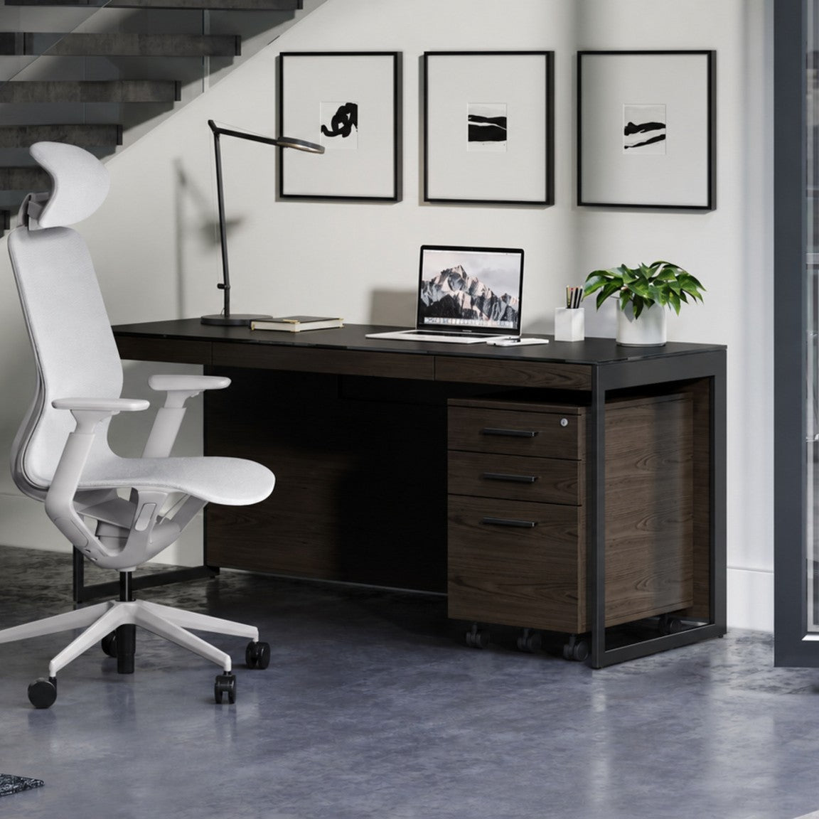 BDi Sequel 20 6101 Desk in Charcoal Stained Ash, with a black frame and mobile file, in an office under a stair
