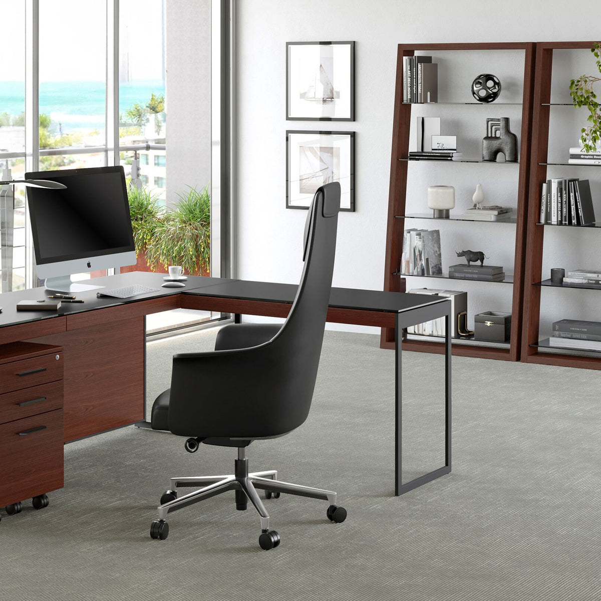 BDi Sequel 20 6112 Desk Extension in Chocolate Stained Walnut, with a black frame, joined to the desk, in an office with shelving