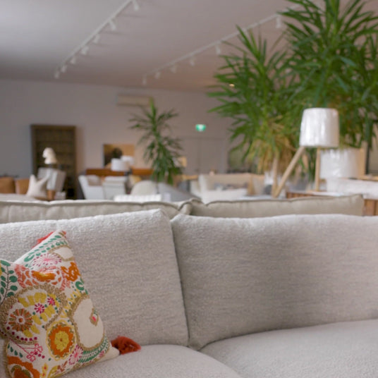 The Valley Ridge Furniture showroom floor, with sofas, lamps and tall palms under track lighting