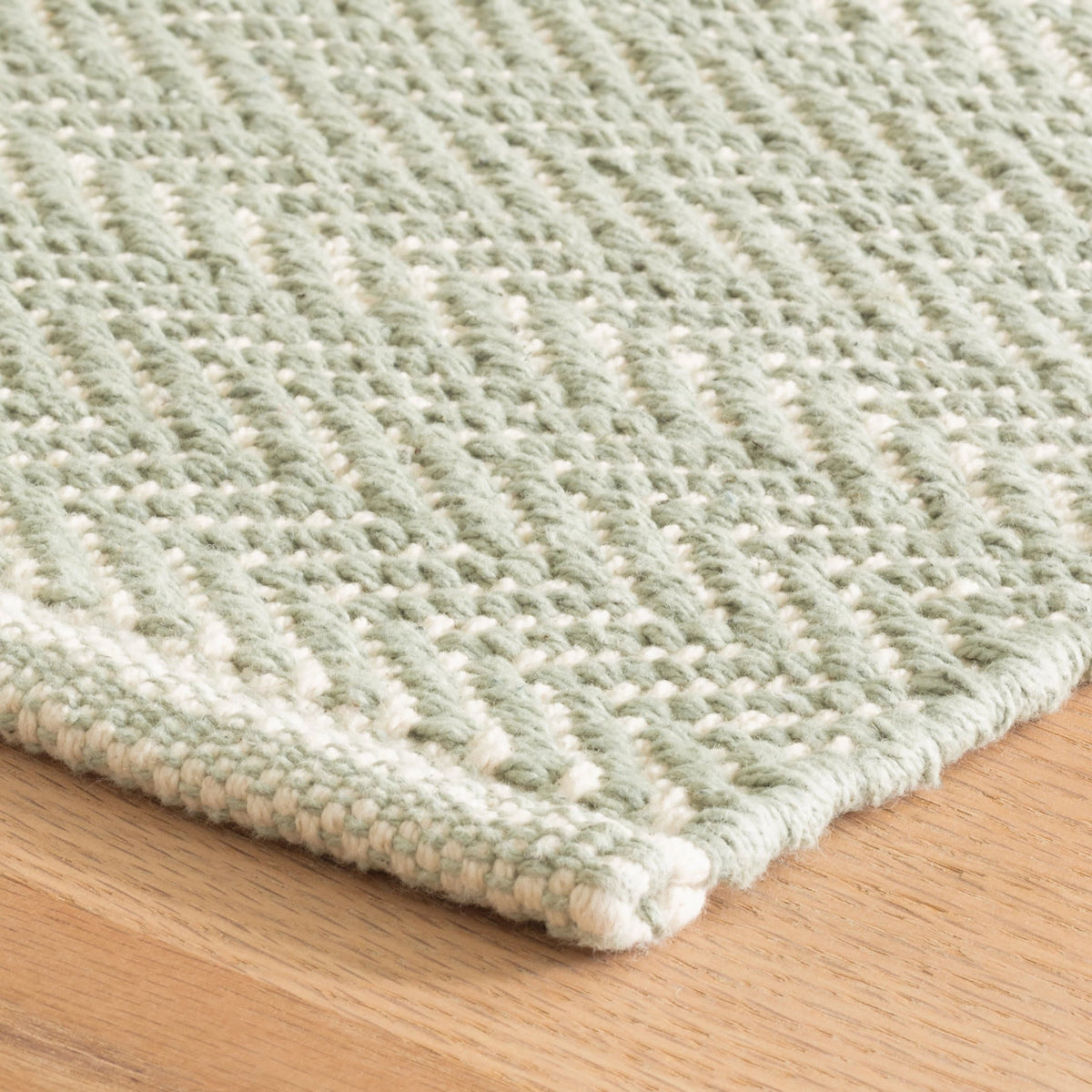 Dash & Albert Herringbone Handwoven Cotton Rug in Ocean, corner detail