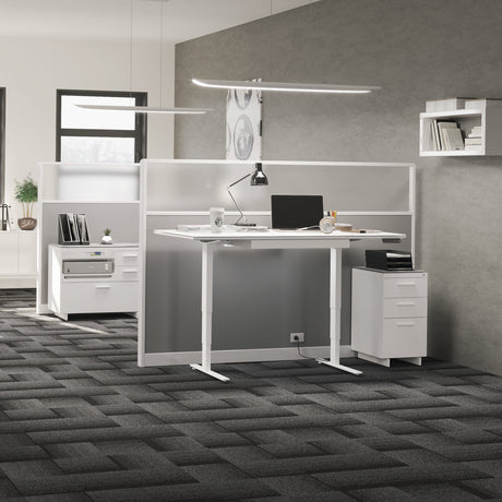 BDi Centro 6414 3 Drawer File Cabinet in Satin White on Oak with Grey Glass, beside a standing desk, in an open office