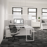 BDi Centro 6401 Desk in Satin White on Oak with Grey Glass, with a return, in an open office