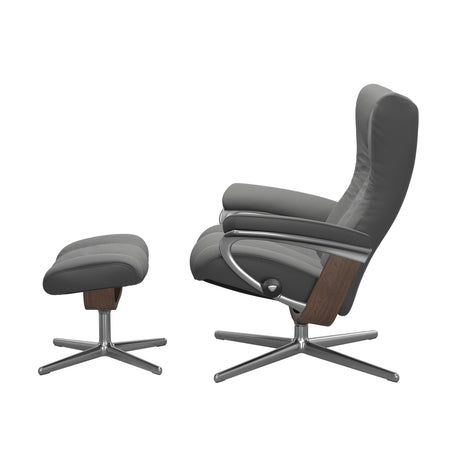 Stressless Wing Recliner Cross Base in Paloma Neutral Grey, side view with footstool, Walnut side panels, size Small
