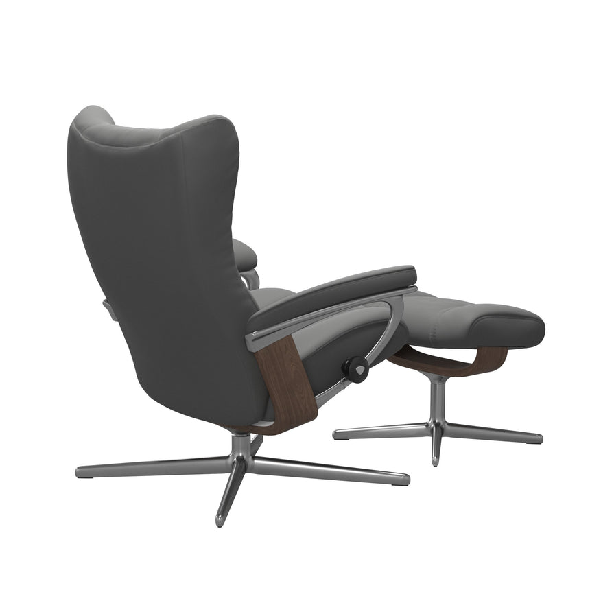 Stressless Wing Recliner Cross Base in Paloma Neutral Grey, three-quarter back view reclined with footstool, Walnut side panels, size Small