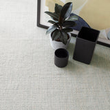 Dash & Albert Marled Handwoven Cotton Rug in Light Blue, close-up with a plant