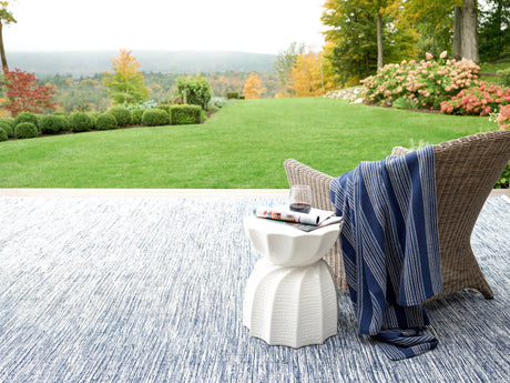 Dash & Albert Tideline Handwoven Indoor/Outdoor Rug in Navy, garden patio setting