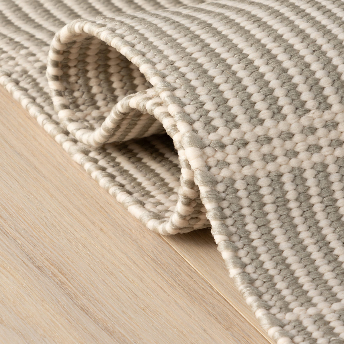 Dash & Albert Marlo Handwoven Indoor/Outdoor Rug in Platinum, folded