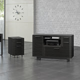 BDi Corridor 6520 Multi Function Cabinet in Charcoal Stained Ash, beside a desk and file pedestal in an office