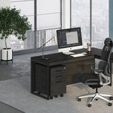 BDi Sequel 20 6107 Mobile File Cabinet in Charcoal Stained Ash, under an L-shaped desk, in an office