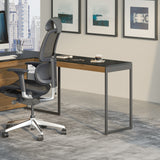 BDi Sequel 20 6112 Desk Extension in Natural Walnut, with a black frame, joined to the desk with a mobile file, in an office