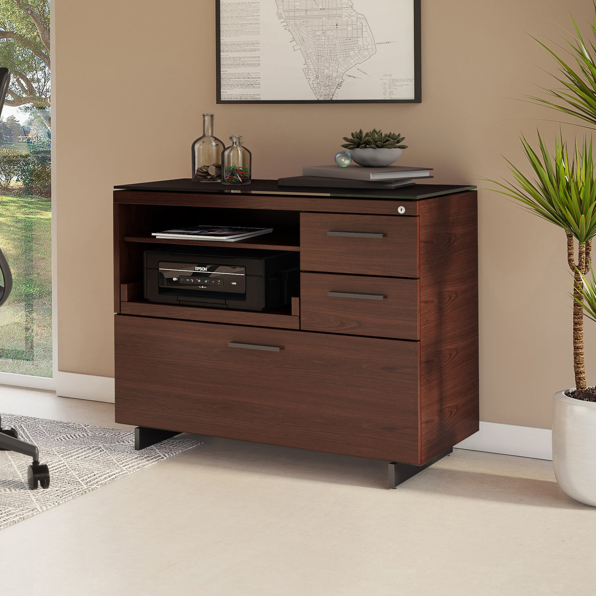 BDi Sequel 20 6117 Multi Function Cabinet in Chocolate Stained Walnut, with a black base, beside a desk, in a home office
