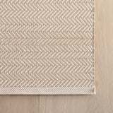 Dash & Albert Herringbone Handwoven Indoor/Outdoor Rug in Linen / White, corner detail