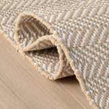 Dash & Albert Herringbone Handwoven Indoor/Outdoor Rug in Linen / White, folded