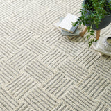 Dash & Albert Layers Hand Hooked Wool Rug in Grey, close-up with books