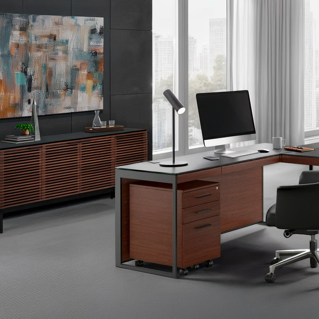 BDi Sequel 20 6107 Mobile File Cabinet in Chocolate Stained Walnut, under an L-shaped desk, in an office