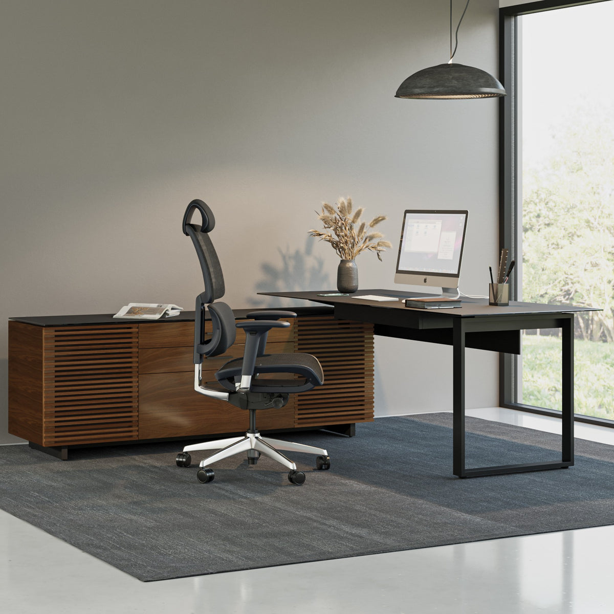 BDi Corridor 6531 L-Shaped Office Desk in Natural Walnut, in an office beside an open staircase