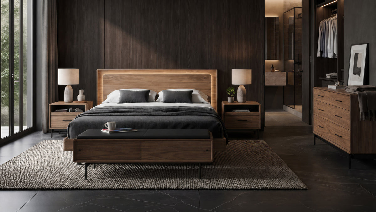 BDi Linq Bench in Pepper | Leather, with a Natural Walnut frame, at the foot of a bed in a dark bedroom