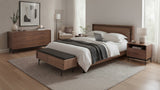 BDi Linq Bench in Pepper | Leather, with a Natural Walnut frame, at the foot of a bed