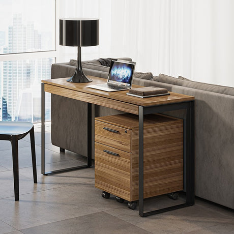 BDi Linea 6222 Console Desk in Natural Walnut, with a mobile file, behind a sofa