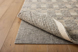 Loloi Loloi- Grip 3/8" Rug Pad in Beige, under a rug on a wood floor