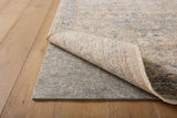 Loloi Loloi- Grip 1/4" Rug Pad in Grey, under a rug on a wood floor